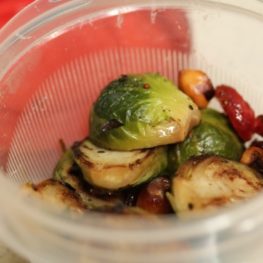 Bowl of veggie pasta tossed with chopped leftover Thanksgiving vegetables like Brussels sprouts, carrots, and green beans
