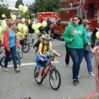 Kids bike and walk in the parade as a part of the Fall City Day Festival