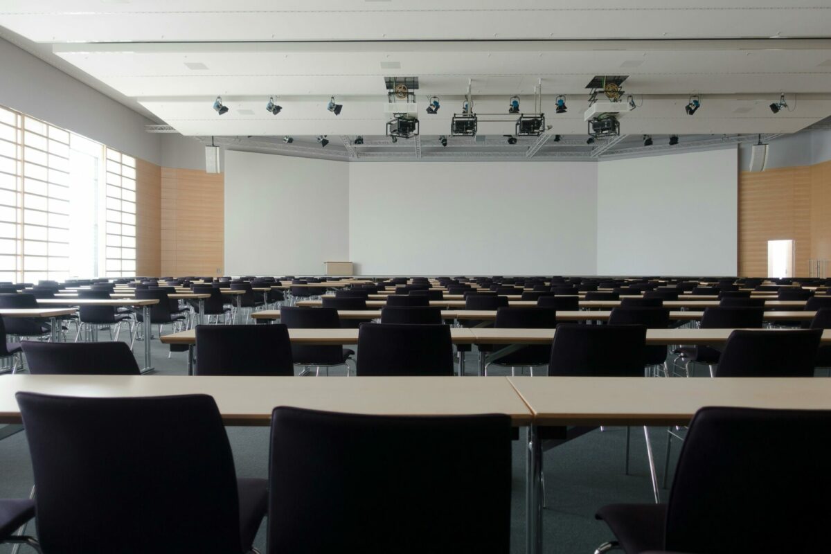Empty chairs lined up in generic classroom